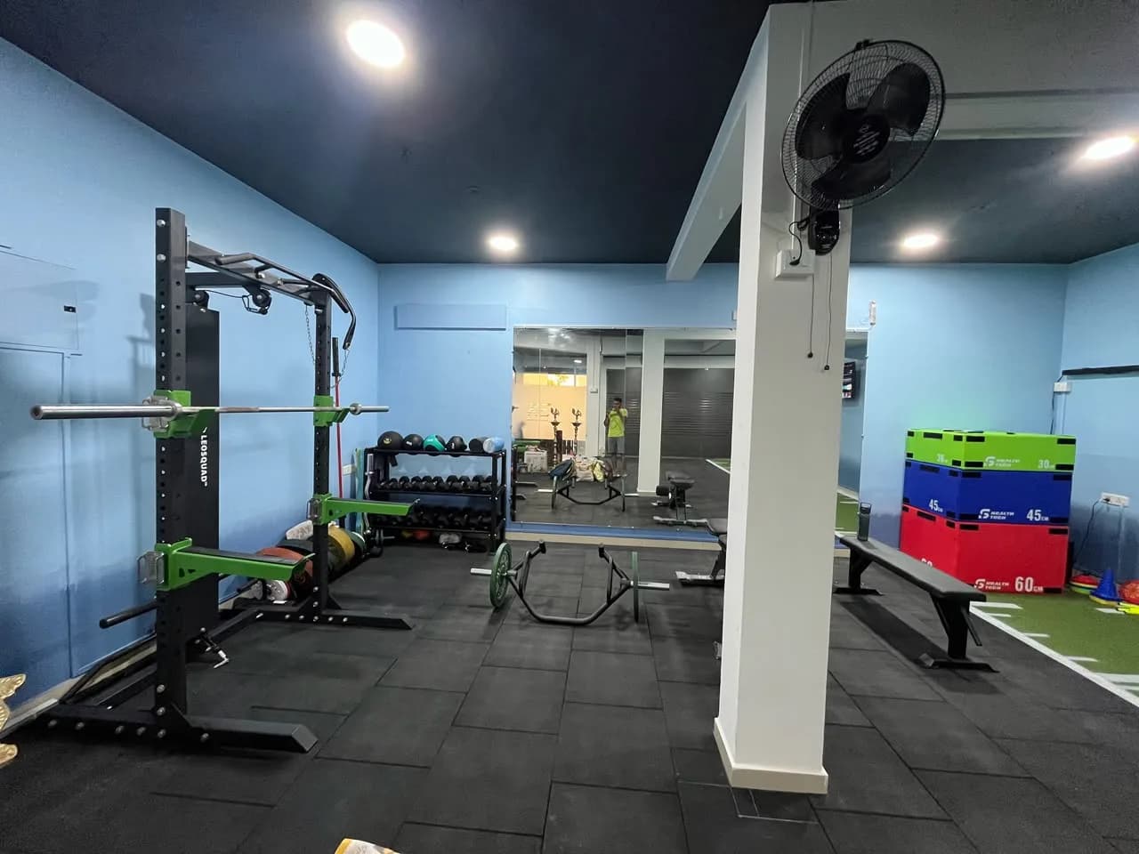 Squat rack, barbells, dumbbells and plyometric boxes on the Kinetic Edge training floor