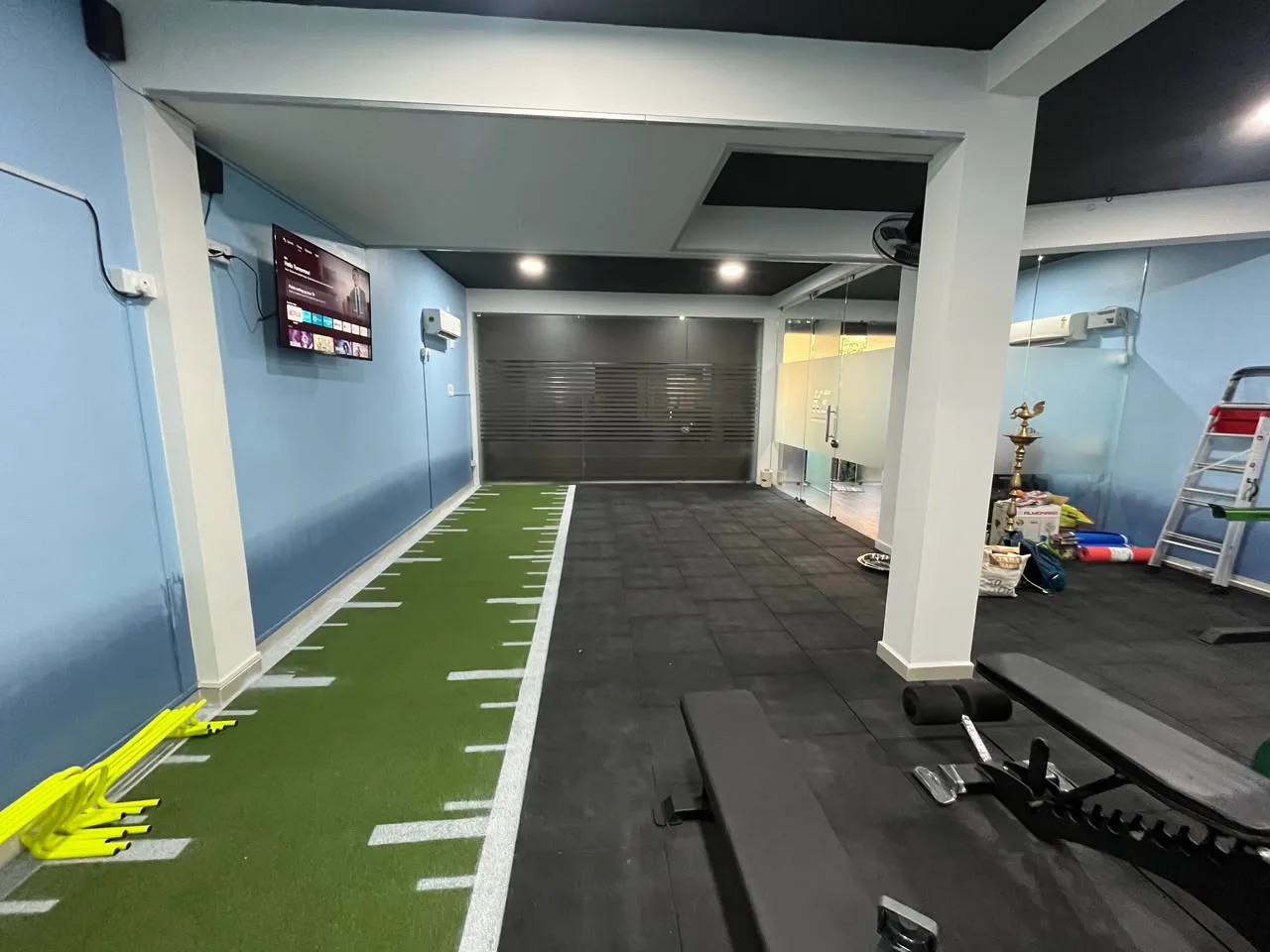 The indoor turf acceleration lane at Kinetic Edge, marked out for speed work